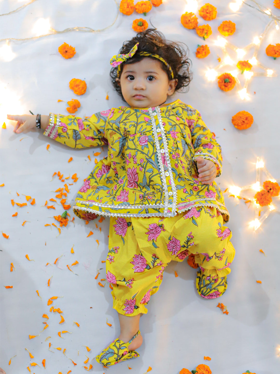 A variety of cotton wear items are displayed, including a top with harem pants, booties, and baby clothes. The collection features Bownbee baby harem pants and children's wear, including a cotton top