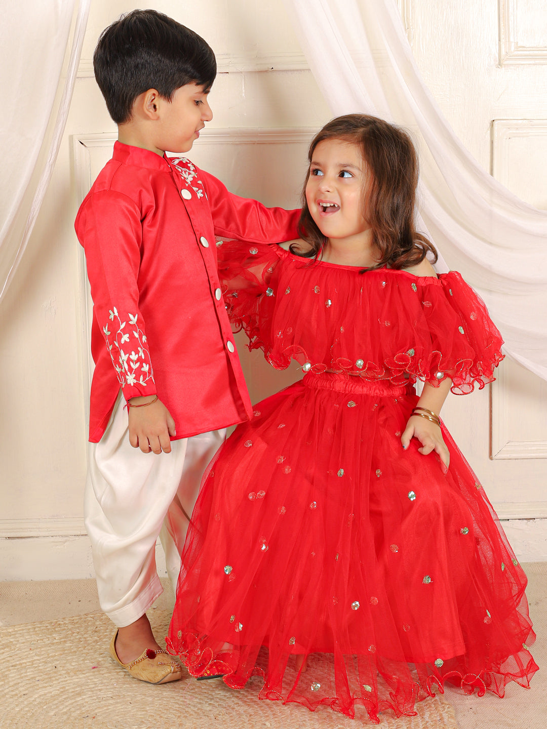 BownBee Sibling Set Hand Embroidered Jam Cotton Sherwani Salwar For Boys- Red with Sequin Net Lehenga with Ruffle Choli with Dupatta- Red