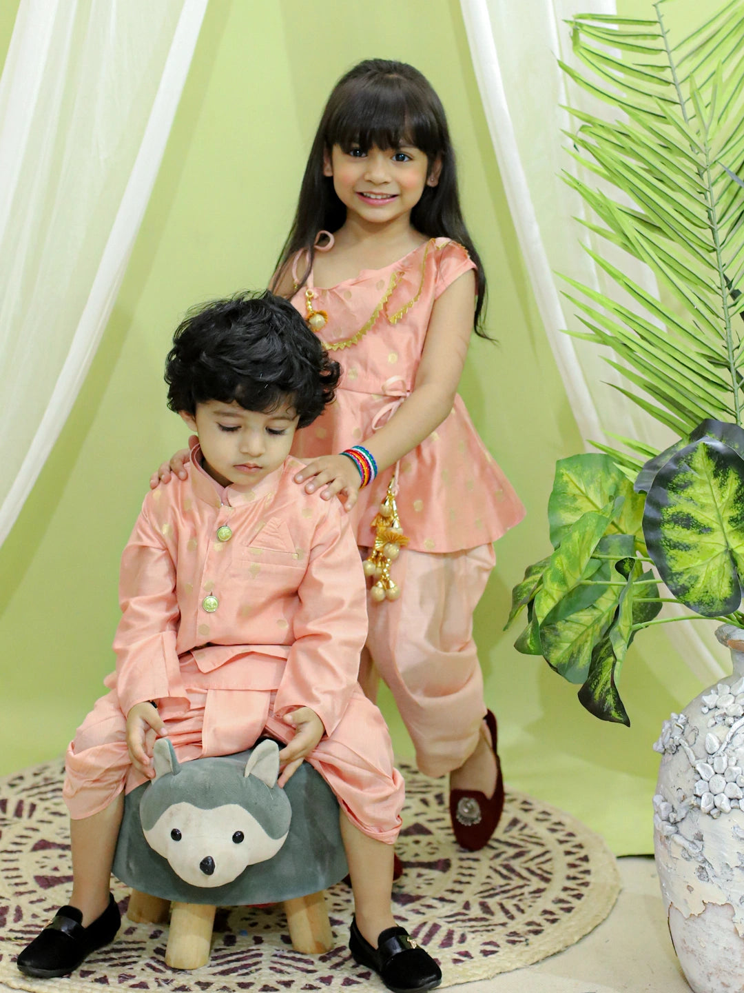 BownBee Sibling Set Chanderi Jacket with Chanderi Dhoti Kurta for Boys- Peach with Chanderi Silk One Shoulder Peplum with Dhoti- Peach