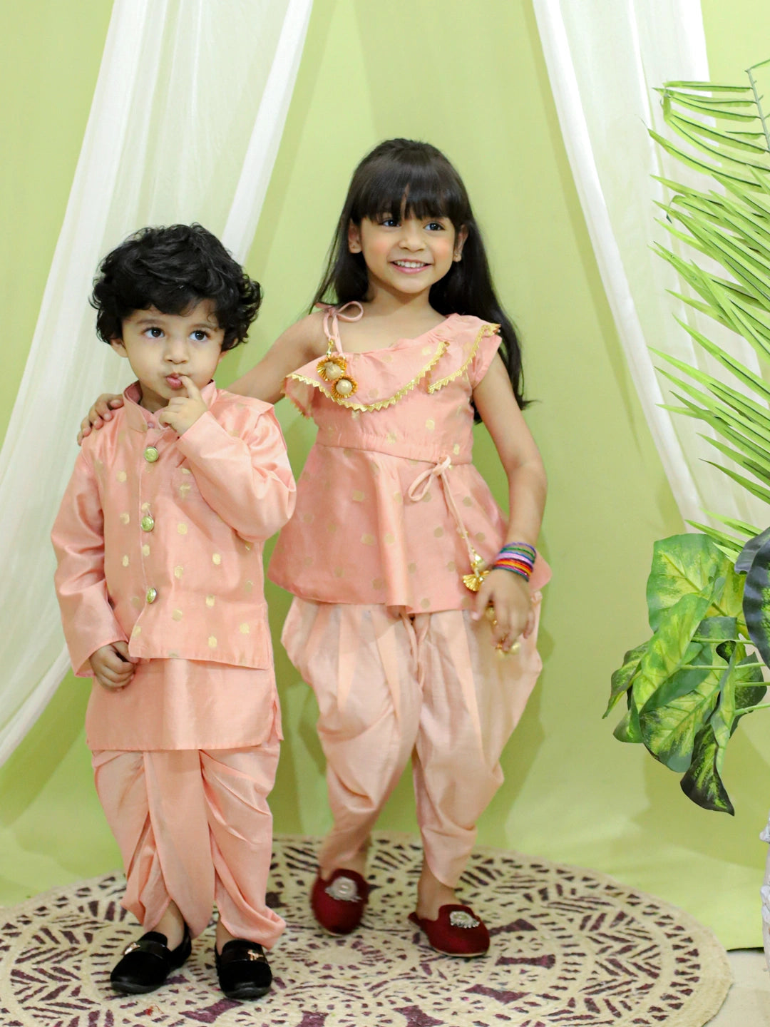BownBee Sibling Set Chanderi Jacket with Chanderi Dhoti Kurta for Boys- Peach with Chanderi Silk One Shoulder Peplum with Dhoti- Peach