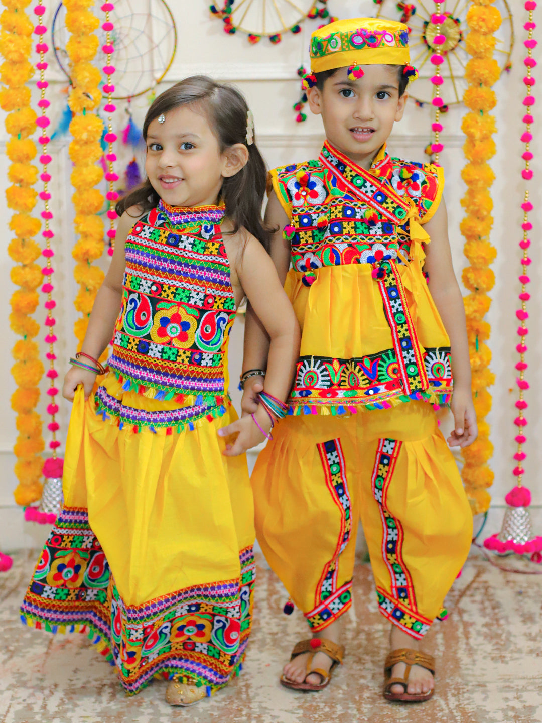 BownBee Sibling Embroidered kediya with Dhoti and Cap for Boys and Bandhani halter neck chaniya choli for Girls - Yellow