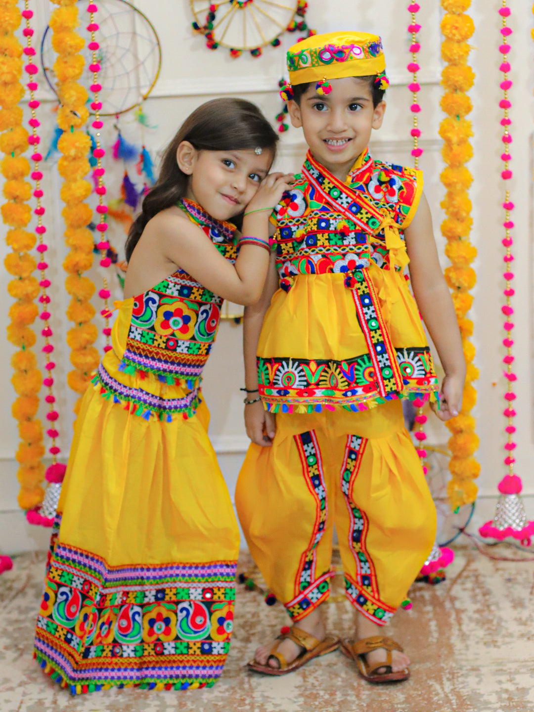 BownBee Sibling Embroidered kediya with Dhoti and Cap for Boys and Bandhani halter neck chaniya choli for Girls - Yellow