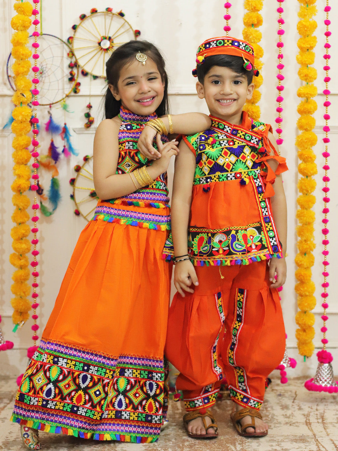 BownBee Sibling Embroidered kediya with Dhoti and Cap for Boys and Bandhani halter neck chaniya choli - Orange